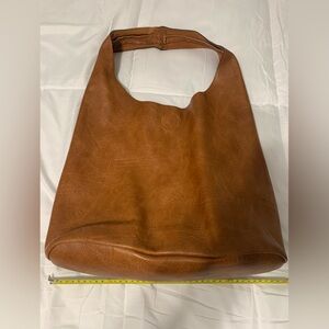 Brown bag. Snap closure. Soft material. Unsure if real leather.